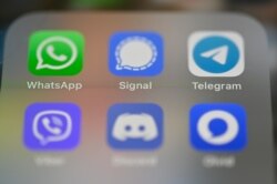 FILE - This picture taken on Jan. 22, 2021 in Rennes, France, shows a smartphone screen featuring messaging service applications WhatsApp, Signal, telegram, Viber, Discord and Olvid.
