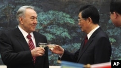 Kazakhstan's President Nursultan Nazarbayev and his Chinese counterpart, Hu Jintao, toast during a signing ceremony at the Great Hall of the People, Beijing, Feb. 22, 2011.