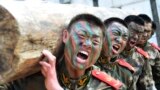 Paramilitary policemen shout as they lift a log during a winter training session at a military base in Chaohu, Anhui province, China.