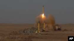 In this Tuesday, July 3, 2012 file photo released by the Iranian Fars News Agency, a surface-to-surface missile is launched during an Iranian Revolutionary Guard maneuver in an undisclosed location in Iran.