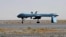 FILE - U.S. Predator unmanned drone armed with a missile stands on the tarmac of Kandahar military airport in Afghanistan. 