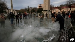 A municipal worker cleans the pavement at the site of Tuesday's explosion in the historic Sultanahmet district in Istanbul, Jan. 13, 2016. 