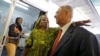 FILE - Fatou Ndeiy, center, of Senegal, greets New York City Democratic Mayoral hopeful Bill Thompson as he campaigned with members of the West African community at the Malcolm Shabazz Harlem Market in New York.