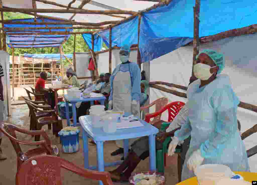 Medical personnel take care of Ebola patients at a clinic on the outskirts of Kenema, Sierra Leone, July 27, 2014.