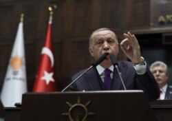 Turkey's President Recep Tayyip Erdogan addresses the members of his ruling party at the parliament, in Ankara, Turkey, Feb. 5, 2020.