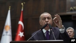 FILE - Turkey's President Recep Tayyip Erdogan addresses the members of his ruling party at the parliament, in Ankara, Turkey, Feb. 5, 2020. 