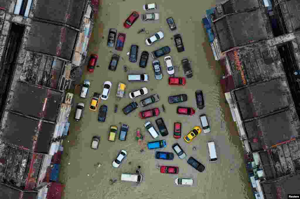 Aerial view shows vehicles and buildings inundated by floods in Shah Alam's Taman Sri Muda, one of the worst hit neighborhoods in Selangor state, Malaysia, Dec. 21, 2021. 