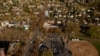 FILE - In an aerial photograph taken with a drone, a group of mostly Venezuelan migrants camp on the tennis courts of a community center after losing access to other shelter in Seattle, Washington, April 3, 2024. 