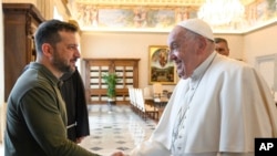 Ukraine's President Volodymyr Zelenskyy, left, arrives for a private audience with Pope Francis at The Vatican, Oct. 11, 2024.