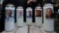 Photos of five journalists adorn candles during a vigil across the street from where they were slain in their newsroom in Annapolis, Md., June 29, 2018.