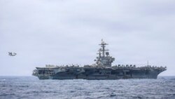 资料照片：美国海军2026年7月10日公布、拍摄于6月29日的照片显示一架F/A-18F“超级大黄蜂”战斗机准备在美国海军尼米兹级核动力航空母舰“乔治·H·W·布什”号的飞行甲板上着陆。