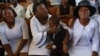 Relatives of Marckendy Natoux, a journalist killed by armed gangs at General Hospital on Dec. 24, 2024, mourn during a funeral service for Natoux in Port-au-Prince, Haiti, Jan. 18, 2025.