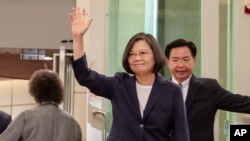 FILE - Photo released by the Taiwan Presidential Office shows Taiwanese President Tsai Ing-wen waving as she leaves for the Caribbean from Taoyuan International Airport in Taoyuan, Taiwan, July 11, 2019.