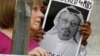 People hold signs during a protest at the Embassy of Saudi Arabia in Washington about the disappearance of Saudi journalist Jamal Khashoggi, Oct. 10, 2018. 