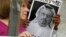 People hold signs during a protest at the Embassy of Saudi Arabia in Washington about the disappearance of Saudi journalist Jamal Khashoggi, Oct. 10, 2018. 