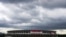 FILE - In this June 23, 2021, file photo, rain clouds move in over National Stadium, in Tokyo. 