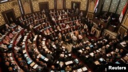 FILE - Newly elected members of Syria's parliament attend the first parlimentary session of the new constitution in Damascus, May 24, 2012. 