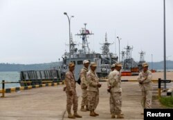 FILE - Sailors stand guard near petrol boats at the Cambodian Ream Naval Base in Sihanoukville, Cambodia, July 26, 2019.