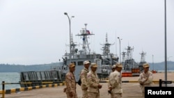Sailors stand guard near petrol boats at the Cambodian Ream Naval Base in Sihanoukville, Cambodia, July 26, 2019.