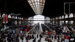 People stand in the hall of the Gare du Nord railway station, in Paris, Dec. 22, 2019. 