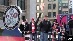 IMAGE DISTRIBUTED FOR T-MOBILE - Veterans and T-Mobile employees wave to the crowd at the Veterans Day Parade on Sunday, Nov. 11, 2018 in New York. (Amy Sussman/AP Images for T-Mobile)