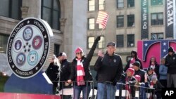 Veterans and T-Mobile employees wave to the crowd at the Veterans Day Parade Nov. 11, 2018 in New York.