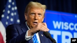 Republican presidential nominee former President Donald Trump speaks at a campaign event in Milwaukee, Wisconsin, Oct. 1, 2024. In a court filing made public Oct. 2, 2024, U.S. prosecutors said Trump acted outside his duties as president following the 2020 election.