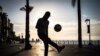 A group play football along Beirut's seafront. 