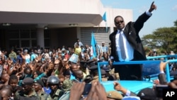 FILE - Newly elected Malawian President Peter Mutharika greets supporters after he was sworn in at the High Court in Blantyre, May 31, 2014.