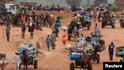 FILE - People fleeing the violence in West Darfur cross the border into Adre, Chad, Aug. 4, 2023.