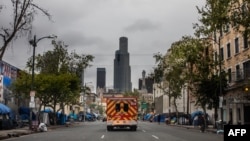 An ambulance of the LAFD Station No9 rides at Skid Row on April 12, 2020 in downtown Los Angeles, California.