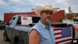 Cowboy David Graham, of Newark, Ohio, on hand with a message of support, stands near his truck across the street from City Hall, Sept. 17, 2024, in Springfield, Ohio.