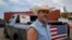 Cowboy David Graham, of Newark, Ohio, on hand with a message of support, stands near his truck across the street from City Hall, Sept. 17, 2024, in Springfield, Ohio.
