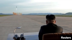 FILE - North Korean leader Kim Jong Un watches the launch of a Hwasong-12 missile in this undated photo released by North Korea's Korean Central News Agency (KCNA).