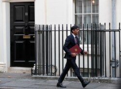 Britain's Chancellor of the Exchequer Rishi Sunak leaves No. 11 Downing Street, heading for the House of Commons to unveil details of his Winter Economy Plan, in London, Sept. 24, 2020.