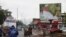 FILE - Motorbike taxis ride past a giant billboard of Mali's incumbent president, Ibrahim Boubacar Keita, that reads "the great Mali advance" in Bamako, Mali, July 18, 2018. As deadly attacks by extremists become more brazen in Mali, officials and citizens fear this month's presidential election will be at risk.