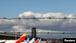 FILE - Airplanes are seen parked on the tarmac at Adolfo Suarez Barajas Airport in Madrid, Spain, Dec. 15, 2020.