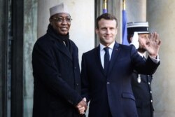 FILE - France's President Emmanuel Macron welcomes Chad's President Idriss Deby at the Elysee presidential palace for a lunch as part of the Paris Peace Forum, Nov. 12, 2019.