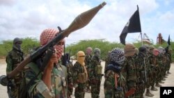 Al-Shabaab fighters display weapons as they conduct military exercises in northern Mogadishu, Somalia, Oct. 21, 2010.