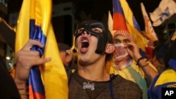 Supporters of presidential candidate Guillermo Lasso protest near the National Electoral Council in Quito, Ecuador, Sunday, April 2, 2017.