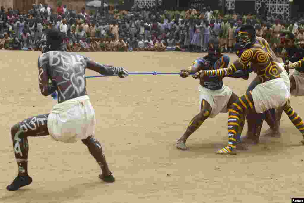 Actors, playing the role of Ebola (on left) and doctors (right), perform during an awareness campaign against the virus at Anono school in Abidjan, Ivory Coast, Sept. 25, 2014. 