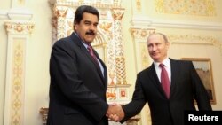 FILE - Russian President Vladimir Putin (R) welcomes Venezuela's President Nicolas Maduro in Moscow in this January 15, 2015, handout from the Miraflores Palace. 