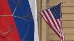 A Russian national tricolor flag flies next to a US national flag sitting on the US embassy building in Moscow on March 13, 2025.