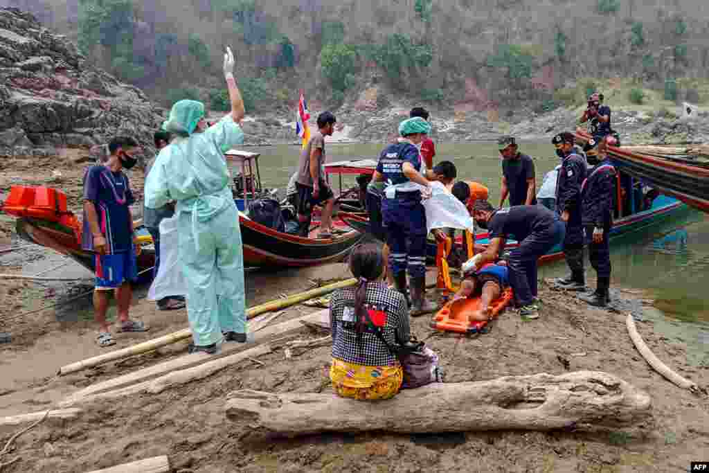 An injured Myanmar refugee is transported to a hospital in Mae Sam Lap, Thailand, after crossing the Salween river from the Myanmar side while fleeing from airstrikes in Myanmar&#39;s eastern Karen state following the military coup.&#160;(Royal Thai Army)