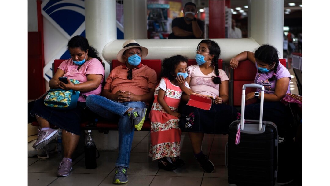 Tourists from Mexico wearing masks as a precaution against the spread of the new coronavirus, wait for their flight home, at the Jose Marti International Airport in Havana, Cuba, March 23, 2020.