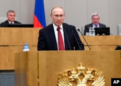 FILE - Russian President Vladimir Putin speaks during a session of the State Duma, the Lower House of the Russian Parliament, prior to its members voting on constitutional amendments, in Moscow, March 10, 2020.