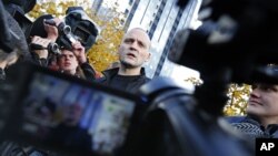 Russian opposition leader Sergei Udaltsov speaks to media after visiting the Russian Investigative Committee's office in Moscow, October 26, 2012.