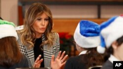 First lady Melania Trump joins local students creating holiday decorations at the Salvation Army Clapton Center in London, Dec. 4, 2019. 