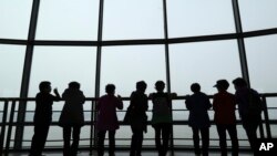 Visitors watch the North Korea side from the unification observatory in Paju, South Korea, April 25, 2017. 