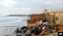 Before last weekend, this pile of rubble was the home of a woman who now stays with neighbors, hoping their homes hold weather the upcoming storms. Behind the pile, is another home that withstood waves residents say were between six and 10 meters high.